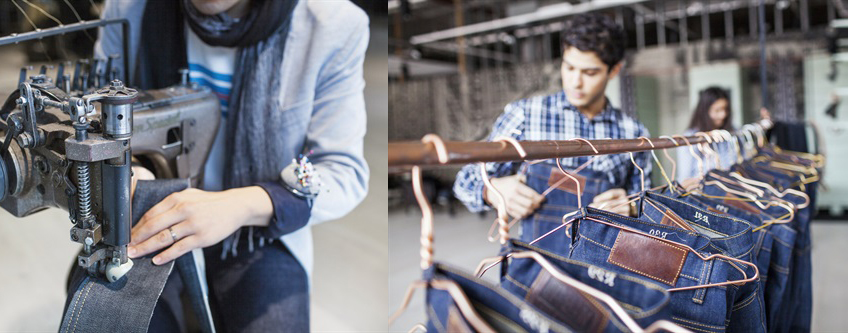 Jeans on clothes bar in a production environment with employees.