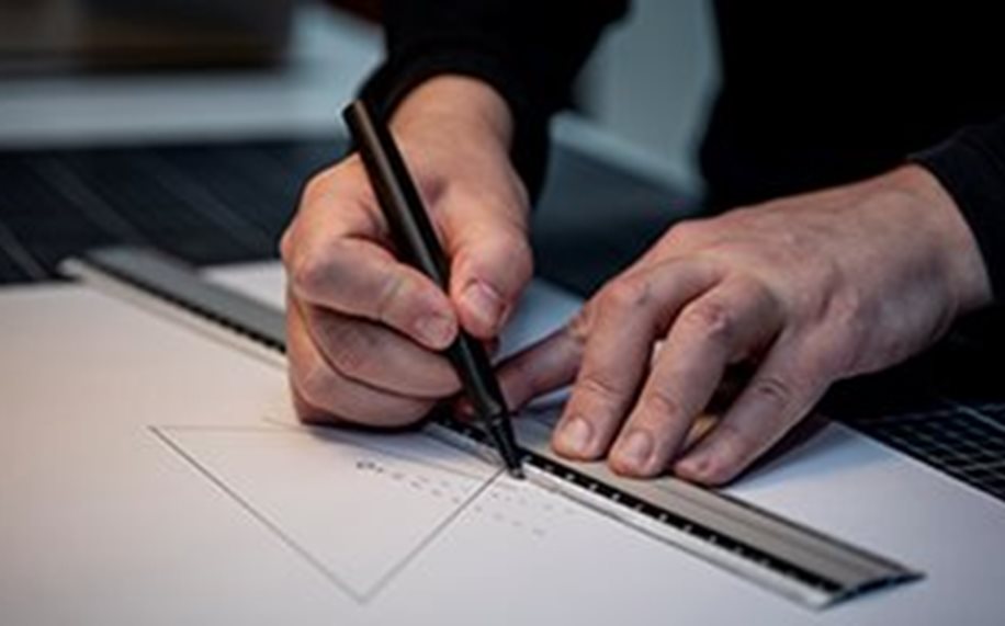 Hands drawing with ruler